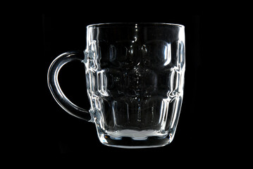 Empty beer mug on black background.
