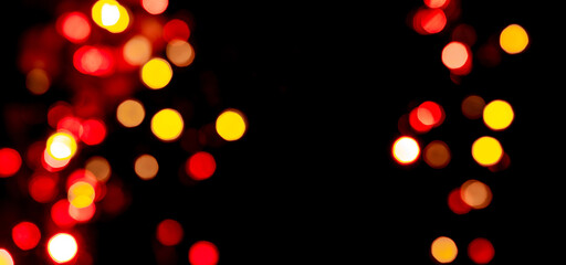 Festive background with colorful bokeh on black background, copy background