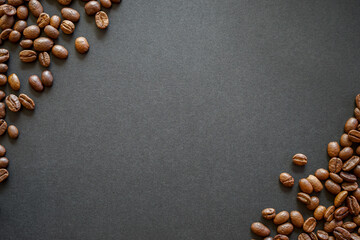 roasted coffee beans in the corner of black paper background for text with copy space 