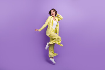 Full length photo of optimistic woman dance jump overjoyed lime style garment funny person good vibe isolated on purple color background