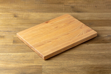 Cutting board on a wooden table.