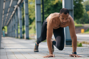 Young handsome man exercising and looking concentrated