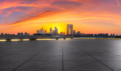 City square and skyline with modern buildings at sunset in Suzhou, Jiangsu Province, China....