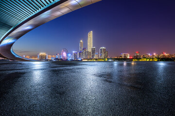 Asphalt road square and bridge with city skyline at night in Suzhou, Jiangsu Province, China.