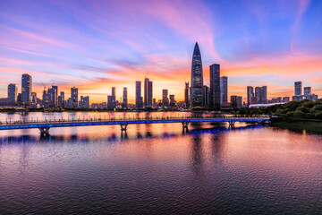 Obraz premium Shenzhen skyline and modern buildings scenery by the lake at sunset, China. Famous modern commercial buildings in Shenzhen.