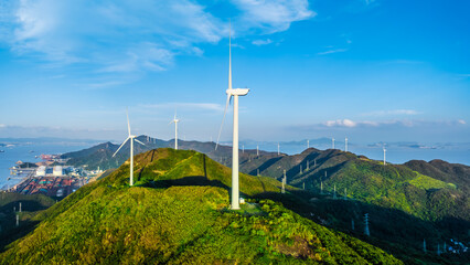 Wind turbines and green mountain nature landscape near the sea. Green energy concept. aerial view. © ABCDstock