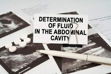 On the ultrasound pictures there is a business card with the inscription -determination of fluid in...