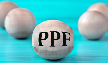 The letters PPF are depicted on a wooden round ball on a blue background