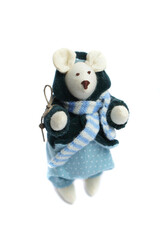 White mouse toy in blue and green dress on white background