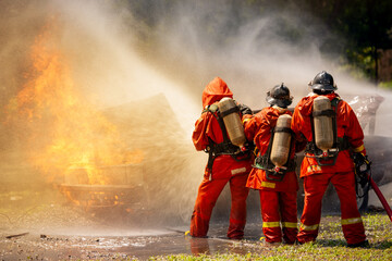 firefighter training fireman team use extinguish spraying fire car. Fire fighter learning stop fire...