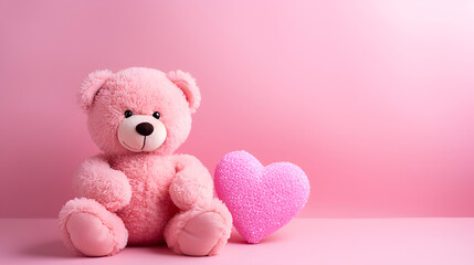 Pink teddy and pink heart on a pink background with copy space. Valentine's Day