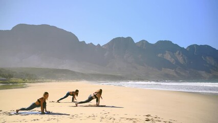 Stretching, beach and women with pilates, yoga and nature with fitness, training and wellness. People, group or friends with workout, sunshine or summer with health, peace or landscape with mountains