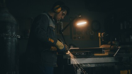 Worker grinding iron - obrazy, fototapety, plakaty