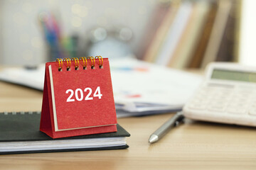 2024 Happy New Year background. 2024 Red calendar on desk. Set up target business and budget...