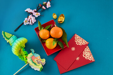 Chinese New Year of Green Dragon. Red packet envelope, flowers, mandarins, festival decorations on...