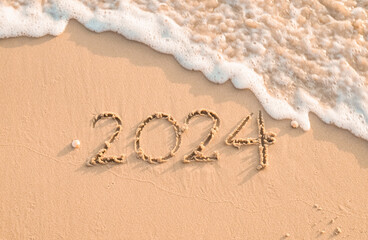 2024 year written on the beach in the sunset time. New Year 2024 concept