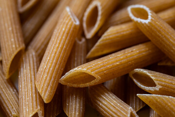 Close up of a pile of uncooked whole wheat pasta