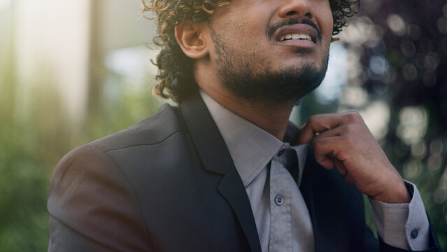 Tired exhausted unwell bad feeling Hispanic businessman suffering high temperature summer in urban city outdoors wearing uncomfortable collar tight shirt Arabian business man stuffiness warm heat hot
