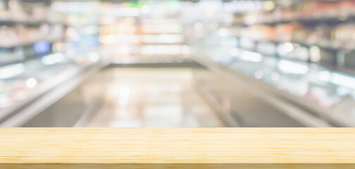 Empty wood table top with supermarket blurred background for product display