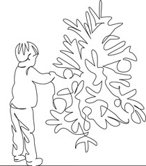 little boy decorating the Christmas tree