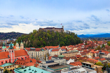 View of the old town and the medieval Ljubljana castle on top of a forest hill in Ljubljana,...