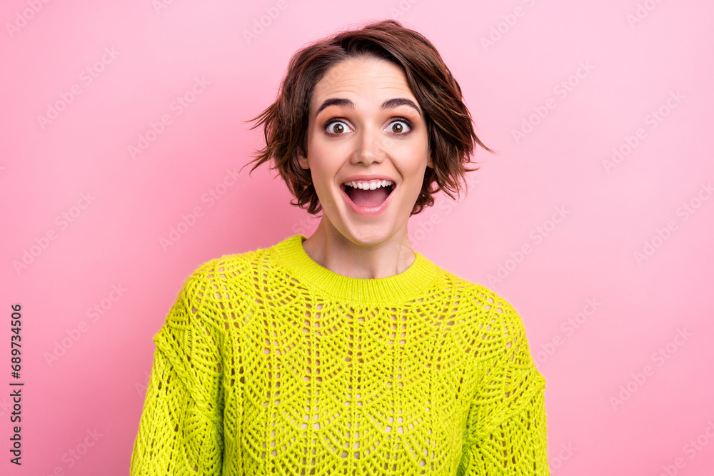 Poster Photo of astonished girl model in yellow knitwear jumper shocked when see prices at supermarket isolated over pink color background