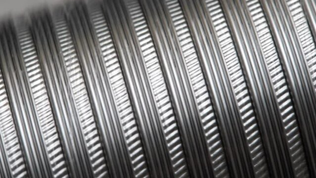 Simple shiny silver metal aluminum tin pipe structure macro detail, extreme closeup shot, nobody. Industrial parts, material production, steel and alloys factory handling simple abstract concept