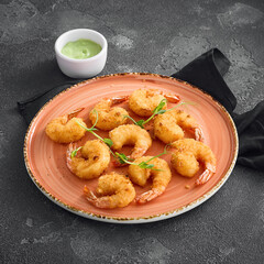 Crispy tempura shrimp elegantly arranged on a round ceramic plate, ready to be enjoyed, against a dark, textured background