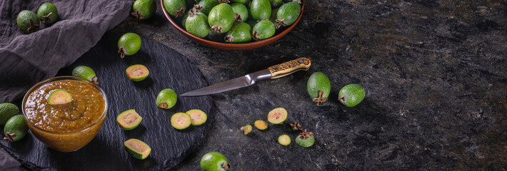Tropical fruits green ripe feijoa sellowiana berries and jam from it. Banner with copy space for...