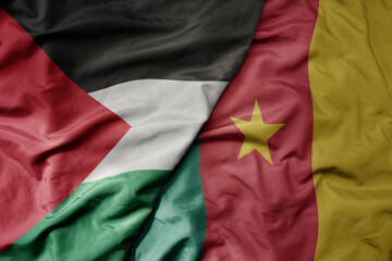 big waving national colorful flag of cameroon and national flag of palestine .