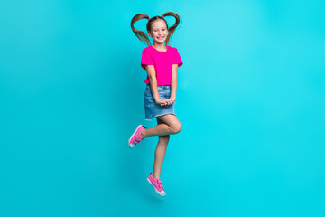 Full size photo of cute good mood pleasant girl dressed pink t-shirt denim skirt flying smiling isolated on turquoise color background