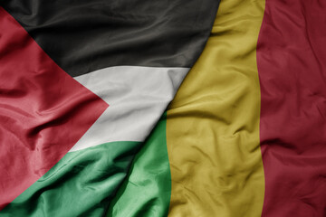 big waving national colorful flag of mali and national flag of palestine .