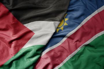 big waving national colorful flag of namibia and national flag of palestine .