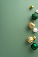 Sleek holiday ambiance. Overhead vertical image featuring set of lavish baubles, and sparkling gold...