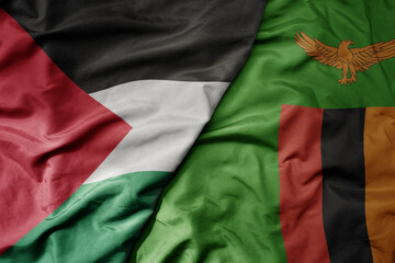 big waving national colorful flag of zambia and national flag of palestine .