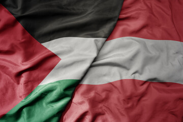 big waving national colorful flag of austria and national flag of palestine .