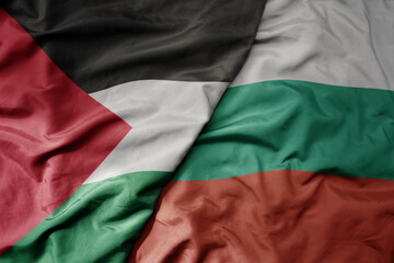 big waving national colorful flag of bulgaria and national flag of palestine .