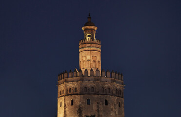Fototapeta na wymiar Seville, spain - november 10, 2018: Illuminated golden tower of Seville