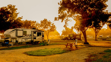 Rv motorhomes and other Rv equipment parked at campsites - Powered by Adobe