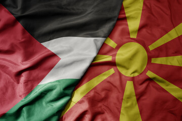 big waving national colorful flag of macedonia and national flag of palestine .