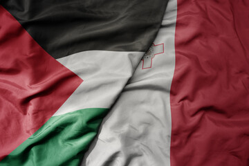 big waving national colorful flag of malta and national flag of palestine .