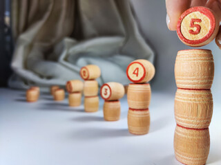Small wooden barrels with numbers built in columns. The concept of duration and ways to achieve the...