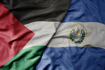 Fototapeta premium big waving national colorful flag of el salvador and national flag of palestine .