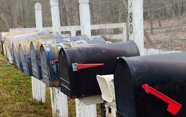Rural mailboxes sit all in a row awaiting mail and news