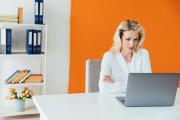 Business woman in office at laptop small business online