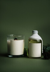 A mockup of aromatic diffuser and candles in glass with a blank label for the product logo. Template for designers