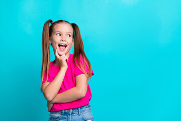 Portrait of excited creative girl finger touch chin open mouth look empty space isolated on...