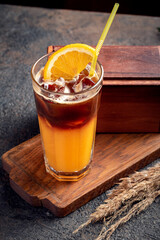 Orange coffee in a glass cup. Refreshing Cold Americano coffee with orange juice.