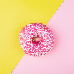 Pink donut on color background, flat lay, top view