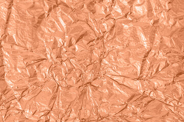 Background of crumpled pink metal foil